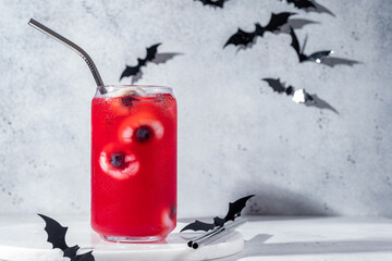 Red halloween cocktail with lychee and blueberry eyeballs