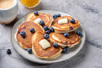 Buttermilk blueberry pancakes with maple syrup and fresh blueberries