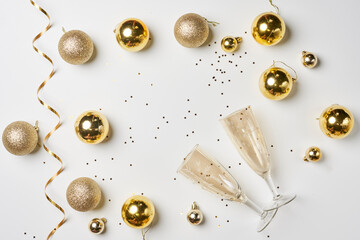 Christmas background with Golden colored decorations on white. New year background with champagne flutes. Celebrate Christmas. New Year Celebration with champagne