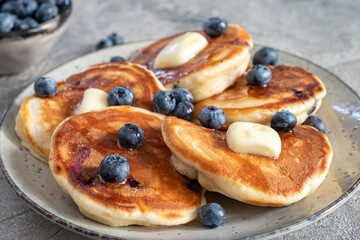 Buttermilk blueberry pancakes with maple syrup and fresh blueberries