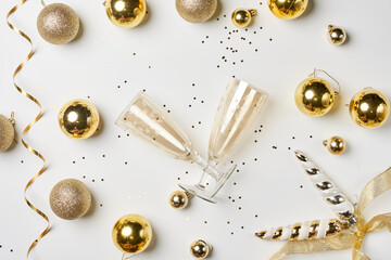 Christmas background with Golden colored decorations on white. New year background with champagne flutes. Celebrate Christmas. New Year Celebration with champagne