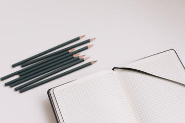 Back to school concept, school and office supplies, top view of notebook and pencils on white background