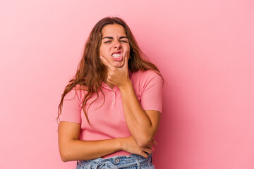 Young caucasian woman isolated on pink background  having a strong teeth pain, molar ache.