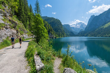 Gosausee, Austria; July 31, 2021 - People hiking at Gosausee, a beautiful lake with moutains in...