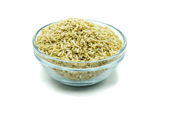 Brown rice in glass bowl isolated on white background