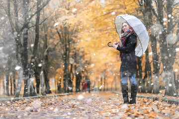 A girl in the park in the first snowfall