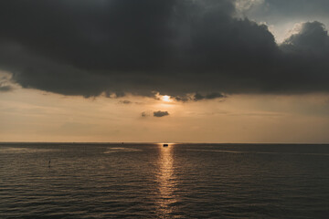 Tiny fishing hut in the middle of sunset and the sea.