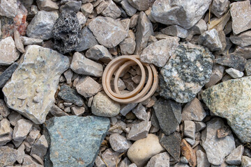 Cut spiral rubber band between the rocks on ground