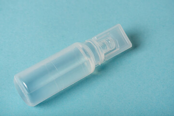Plastic white container with medicine. Close-up on a blue background.