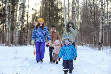 Family with kids in winter park on weekend