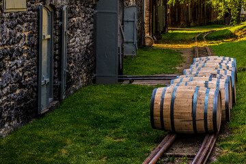 Bourbon barrels lined up to roll. 