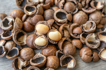 Pile of peeled Macadamia nuts on wooden table