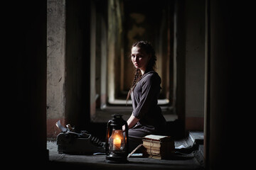 Fototapeta na wymiar A girl with old books in the old house