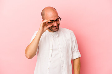 Young caucasian bald man isolated on pink background  joyful laughing a lot. Happiness concept.