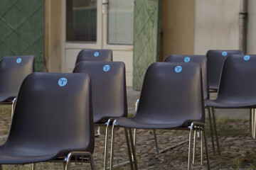 row of empty chairs at an outdoor show