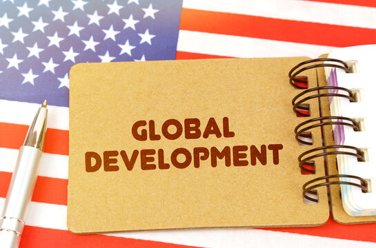 On the US flag lies a notebook with the inscription - Global development