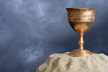 Old chalice over the stone and sky background. 3D Render