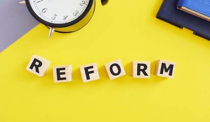 REFORM word written on wooden cubes, Business concept.