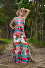 Beautiful and strong mature woman fighting breast cancer disease Smiling and happiness. Hat on site. Hairless and bald. live and joy of fighting. laughter, dancing Sensual flower dress in nature.