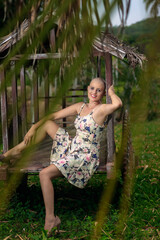 Beautiful and strong mature woman fighting breast cancer disease Smiling and lots of happiness. Hairless and bald. Willingness to live and joy to fight. Sensual dress of flowers in nature.