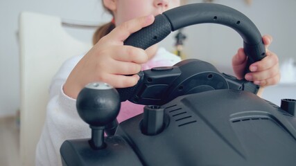 Caucasian Girl Playing Racing Computer Video using Steering Wheel Controller	
