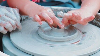 Young Talented Caucasian Girl Taking Pottery Class Trying To Make a Saucer with Wet Clay	