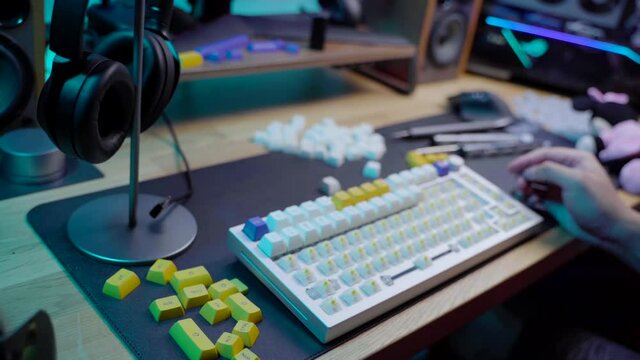 A footage of a man assemble a DIY premium custom keyboard build kit with full alluminium base and bright RGB LED Colors
