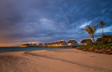 Island in ocean, overwater villas at the time sunset. Crossroads Maldives, hard rock hotel. July 2021. Long exposure picture