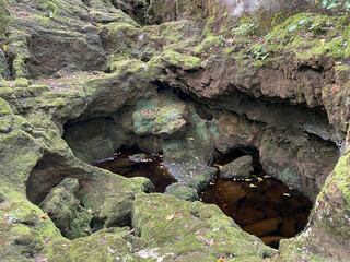 Stones overgrown with tufa and moss in the stream bed under the Zagorska pec cave in the village of...