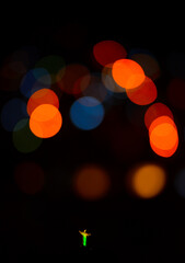 A distant Christ the Redeemer statue with blurred city lights on the foreground, Rio de Janeiro, Brazil