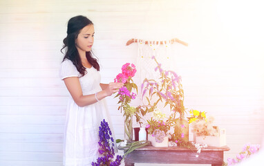 A young girl with a daughter is picking up a bouquet. A young mother with her daughter makes a...