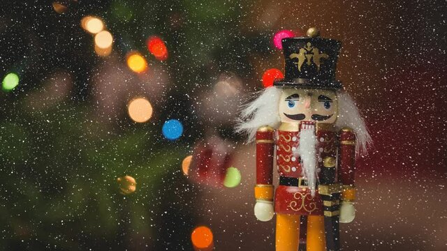 Animation of snow falling over close up of nutcracker