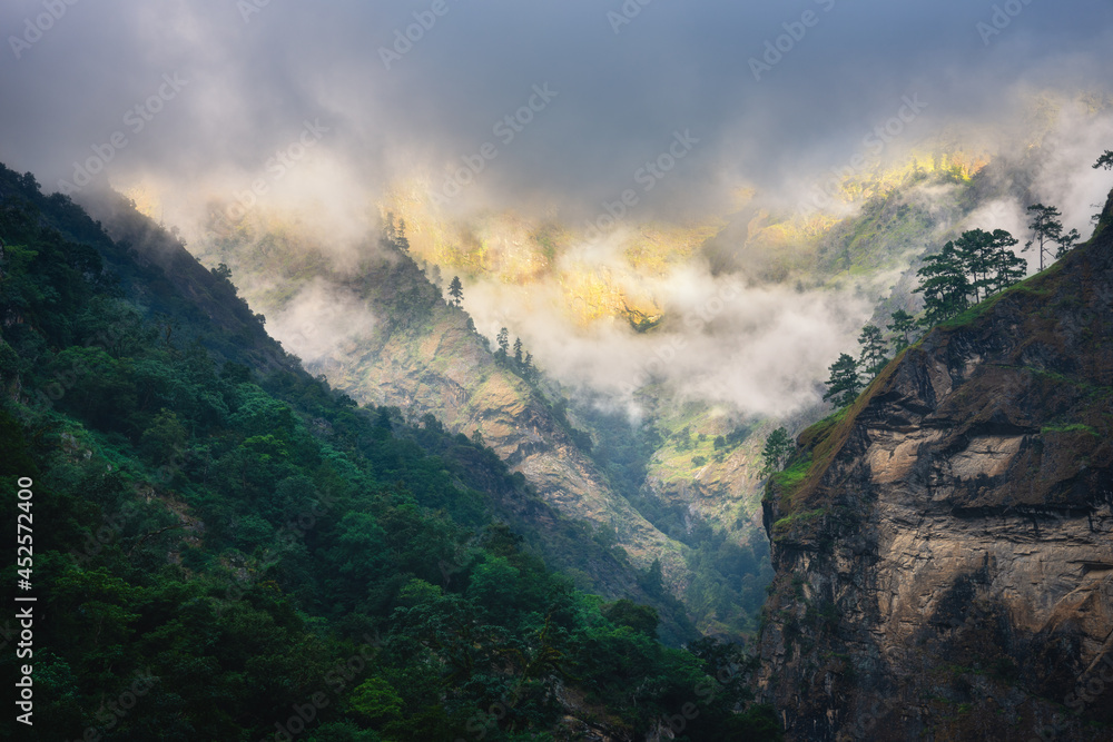 Canvas Prints mountains in low clouds in overcast evening in nepal. moody landscape with beautiful high rocks and 