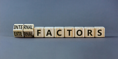 External or internal factors symbol. Turned wooden cubes and changed words external factors to...