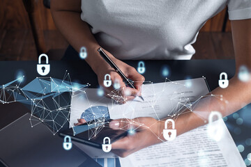 A businesswoman in casual wear signing the contract to prevent probability of risks in cyber...