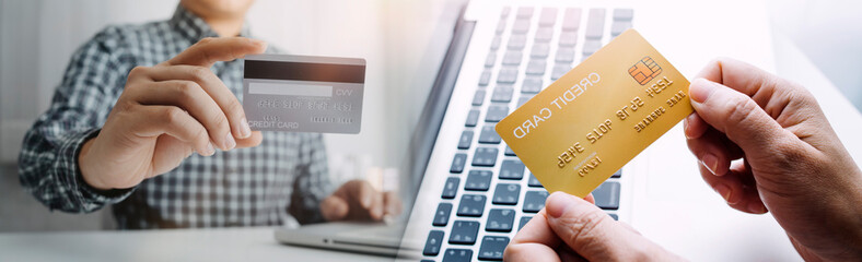 shopping online payment by using laptop.hands holding credit card and using laptop. online shopping concept.