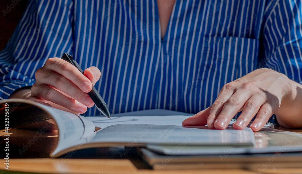 Poster women hands close up writing with pen in notepad, taking notes, studying with syllabus at desk. conc