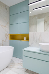 Fototapeta na wymiar Elegant bathroom with blue furniture
