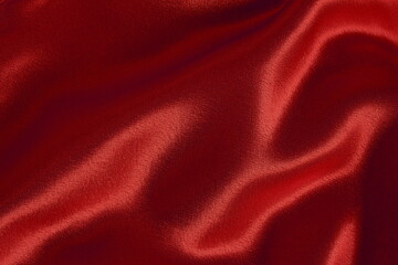 Textile background - draped red satin fabric