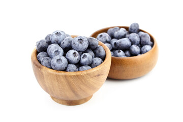 Blueberry in wooden bowl isolated on white background