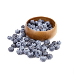 Blueberry in wooden bowl isolated on white background
