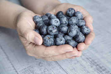 A handful of blueberries on wooden background