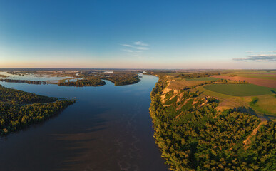 Aerial drone view of river landscape in sunny summer sunset. Top view of siberian Ob river from high attitude in summer sunset. Panorama, bird's eye view
