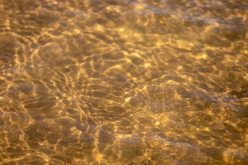 Ripples in the water. sandy bottom of the river.