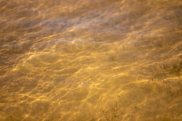 Ripples in the water. sandy bottom of the river.