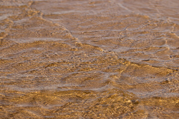 Fototapeta na wymiar Ripples in the water. sandy bottom of the river.