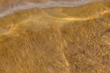 Ripples in the water. sandy bottom of the river.