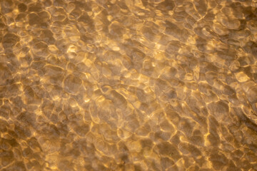 Fototapeta na wymiar Ripples in the water. sandy bottom of the river.