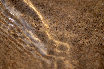 Ripples in the water. sandy bottom of the river.