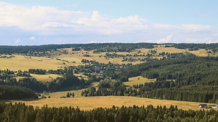 Fototapeta premium A view to the landscape full of meadows and trees from the top of the mountain Plessberg, Czech republic